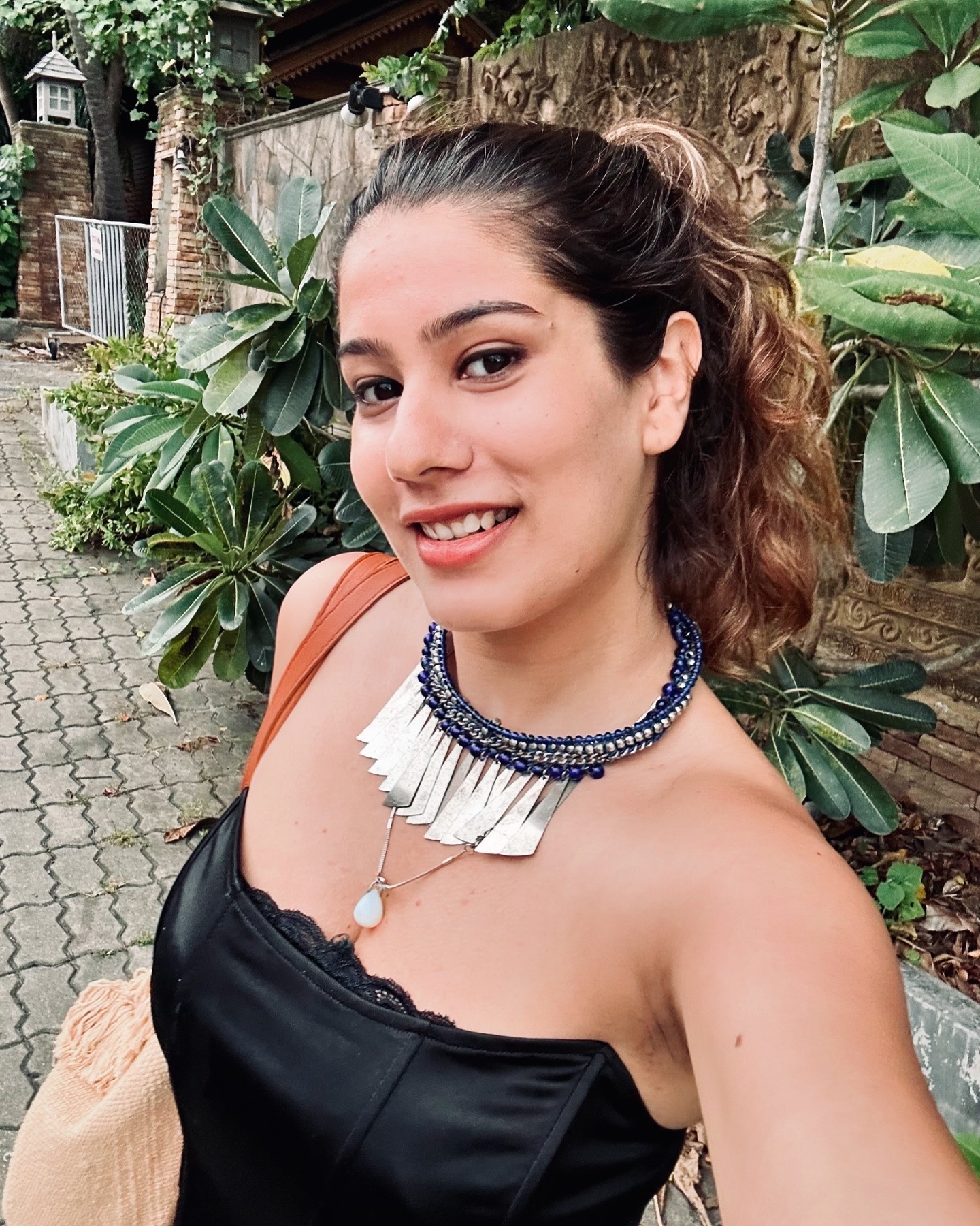 Naincy sitting on wooden deck surrounded by white daisies